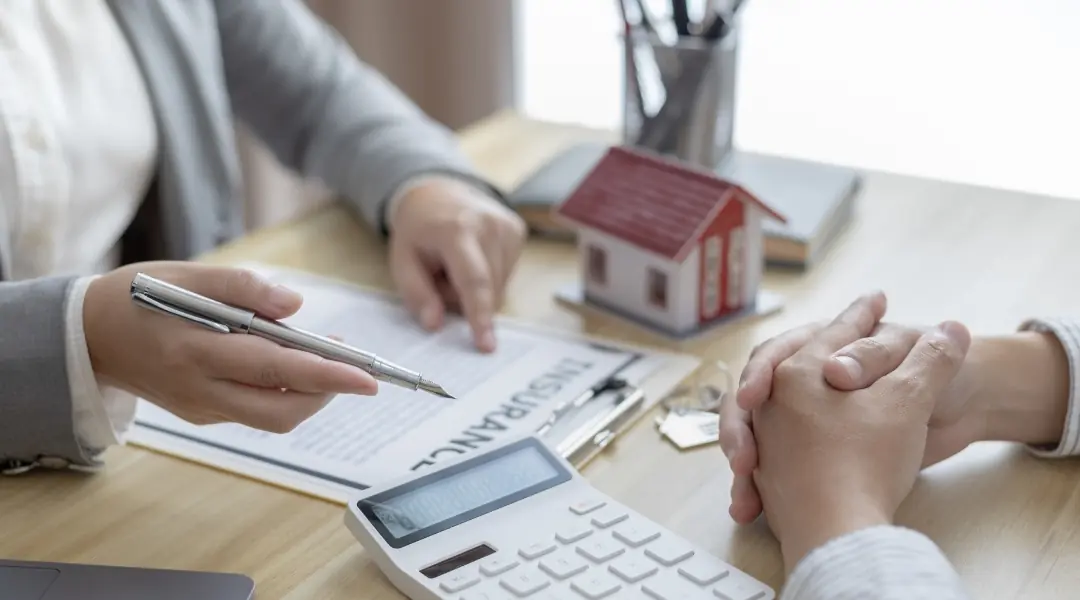 A mortgage advisor reviewing paperwork with clients